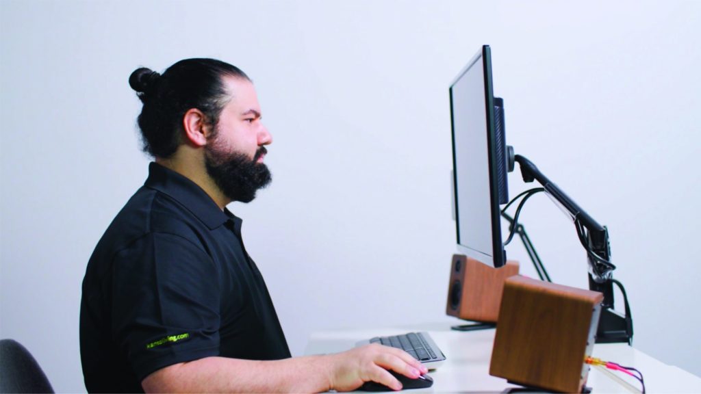 A man working with a Kanto desktop mount