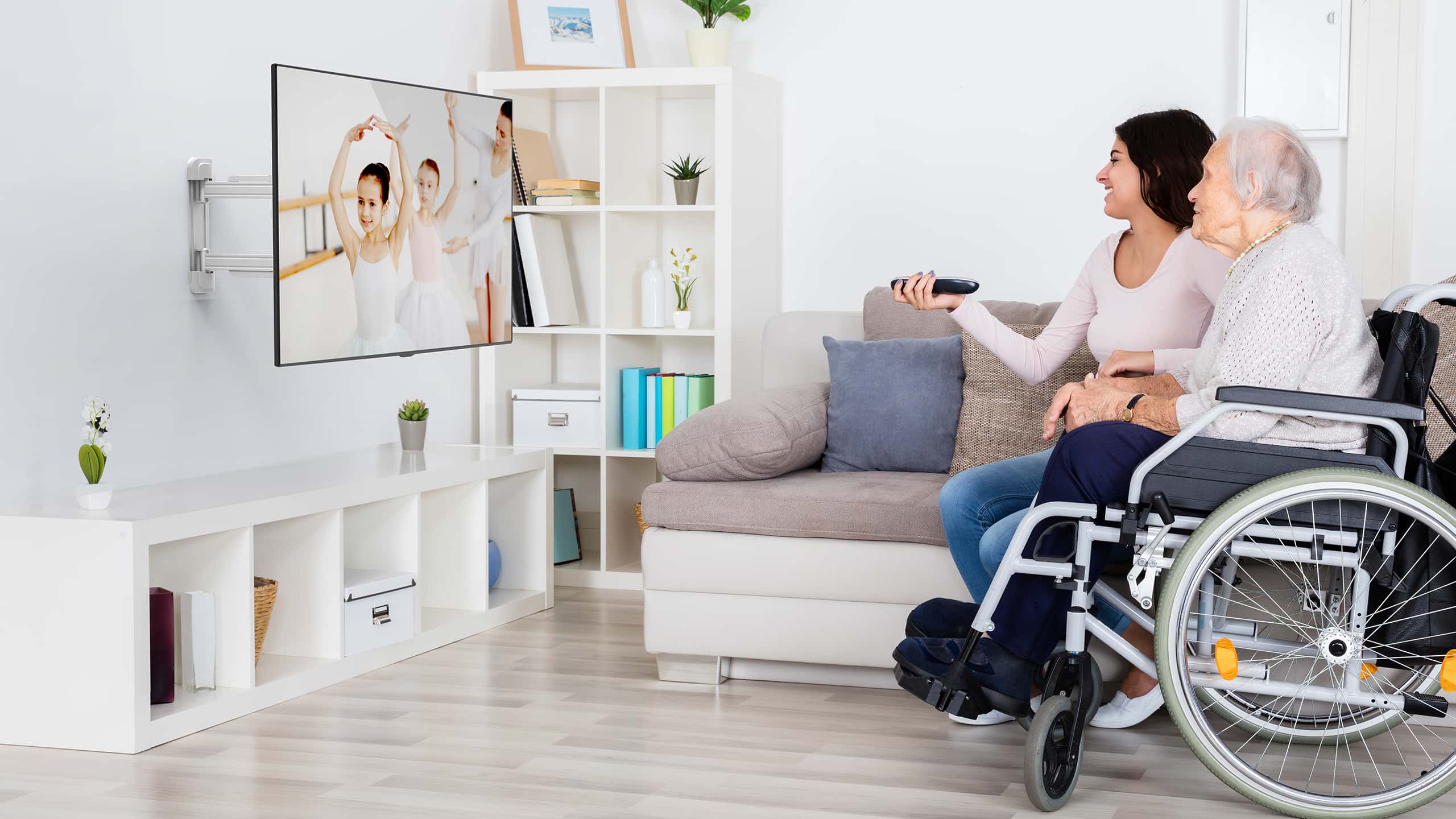Woman and grandmother watching TV